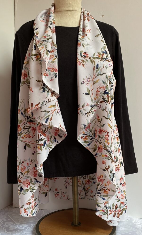 Floral patterns on white vest that's worn five different ways