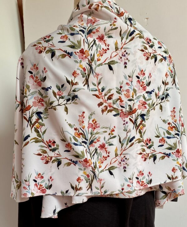 Floral patterns on white vest that's worn five different ways - Image 8