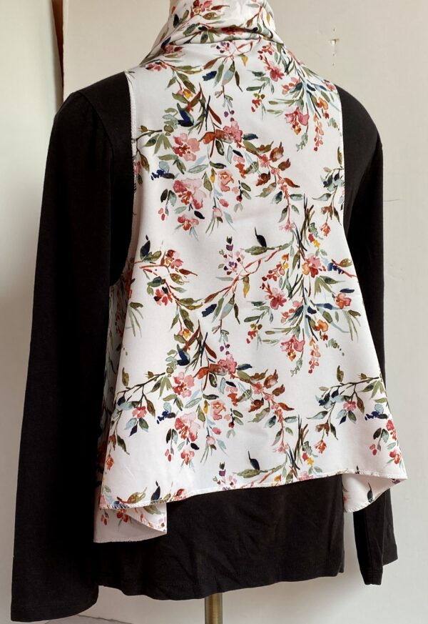 Floral patterns on white vest that's worn five different ways - Image 6