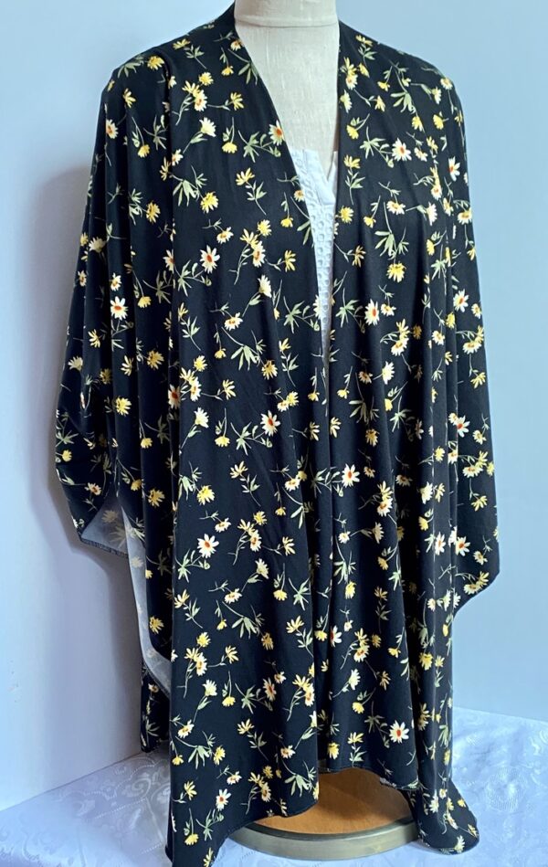 Yellow daisies on black ruana