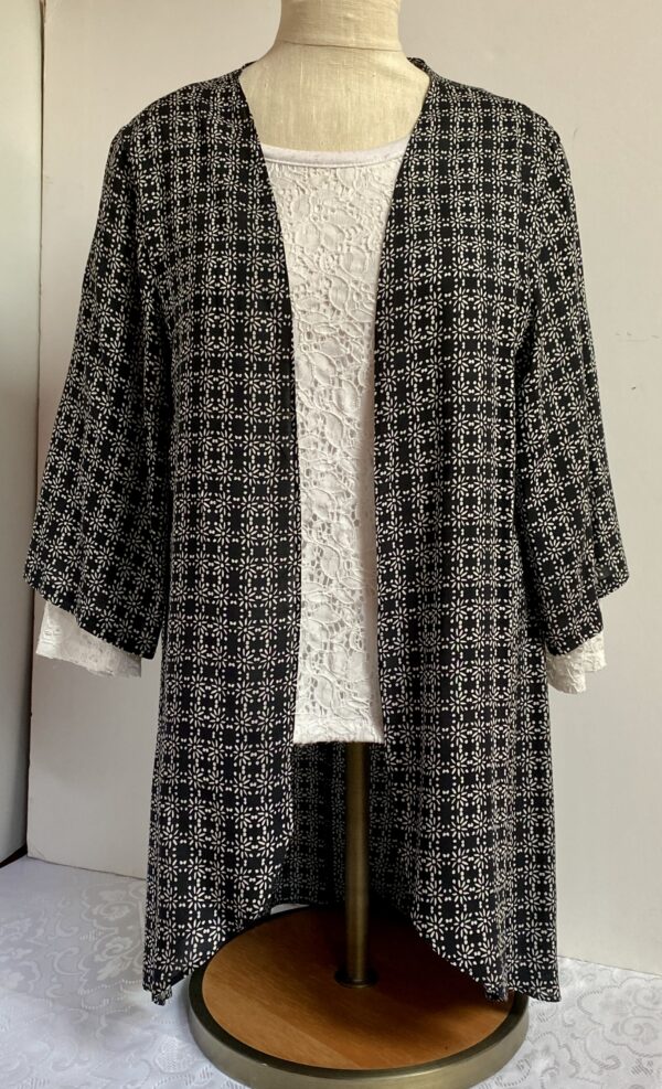 Black poncho with daisy design